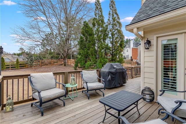 wooden deck with a grill and fence