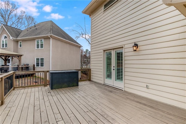 deck featuring french doors and a gazebo