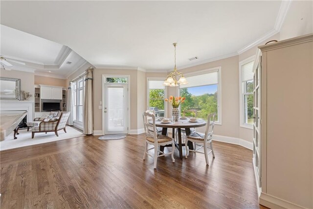 4790 Hyde Rd, Cumming, GA 30040 - dining area featuring a notable chandelier, ornamental molding, wood finished floors, and visible vents