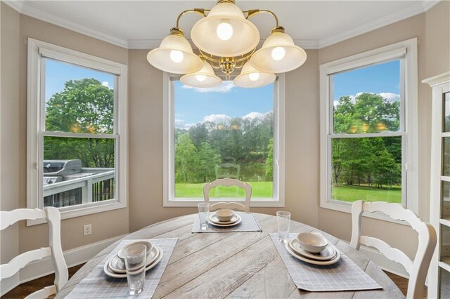 4790 Hyde Rd, Cumming, GA 30040 - dining room with ornamental molding, a notable chandelier, and plenty of natural light