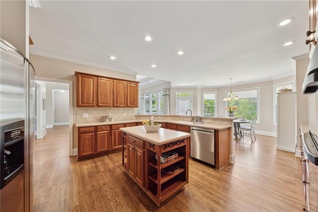 4790 Hyde Rd, Cumming, GA 30040 - kitchen with ornamental molding, a peninsula, appliances with stainless steel finishes, and light countertops