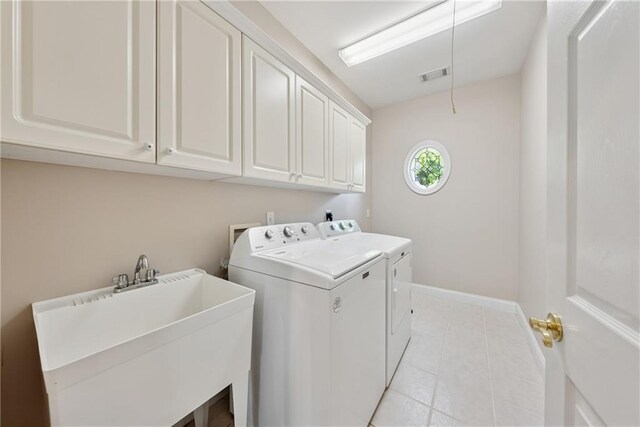 4790 Hyde Rd, Cumming, GA 30040 - laundry area with washer and clothes dryer, a sink, light tile patterned floors, cabinet space, and visible vents