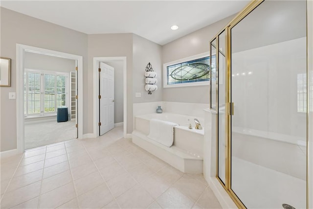 4790 Hyde Rd, Cumming, GA 30040 - full bath featuring plenty of natural light, a garden tub, a shower stall, and tile patterned floors