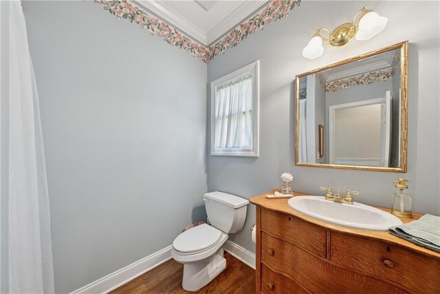 4790 Hyde Rd, Cumming, GA 30040 - bathroom with crown molding, wood finished floors, vanity, baseboards, and toilet