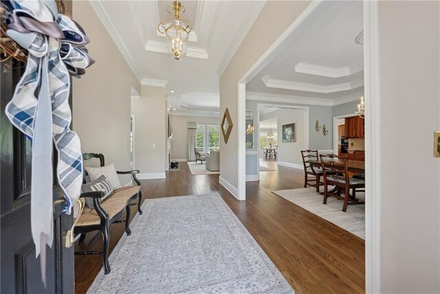 4790 Hyde Rd, Cumming, GA 30040 - entrance foyer featuring a tray ceiling, ornamental molding, dark wood-type flooring, and a notable chandelier