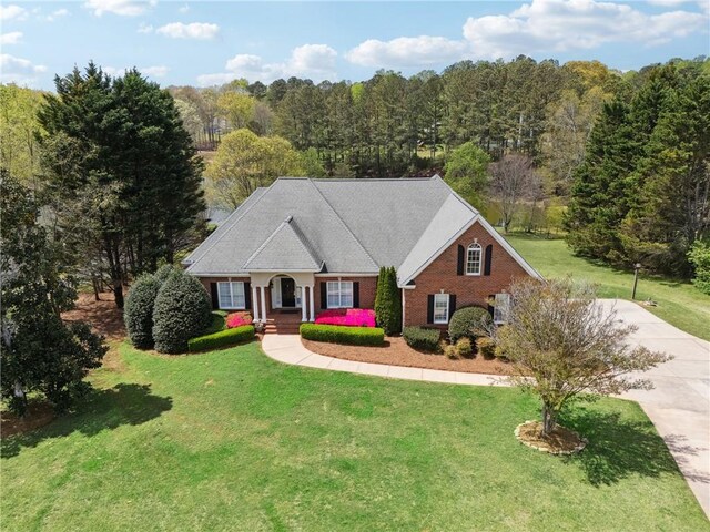4790 Hyde Rd, Cumming, GA 30040 - neoclassical / greek revival house with concrete driveway, a porch, and a front yard