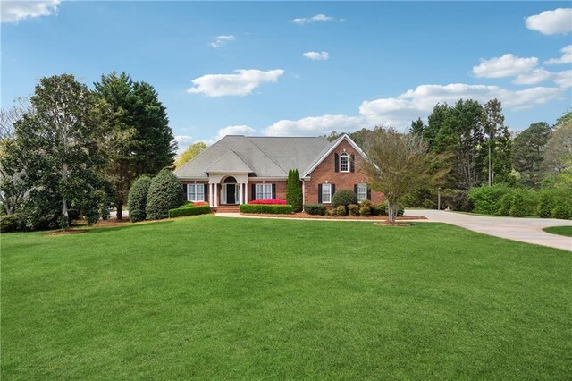4790 Hyde Rd, Cumming, GA 30040 - view of front of home with a front lawn, brick siding, and concrete driveway
