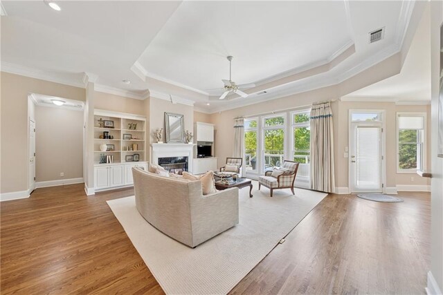 4790 Hyde Rd, Cumming, GA 30040 - living room featuring ceiling fan, light wood finished floors, visible vents, and a fireplace