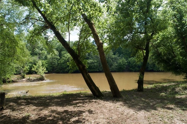 exterior space with a water view and a view of trees