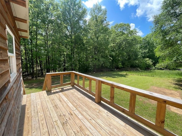 wooden deck featuring a yard
