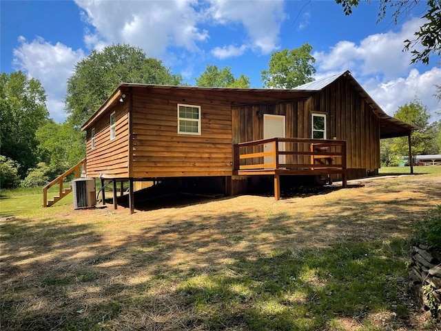 view of front facade with cooling unit, a deck, and stairs