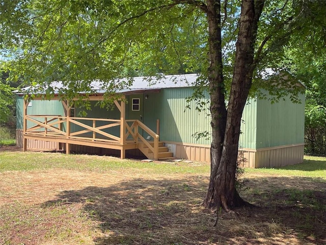 exterior space featuring metal roof and a wooden deck