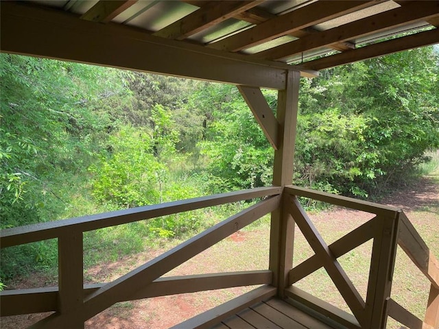 wooden terrace with a view of trees