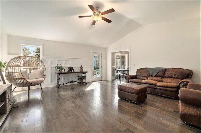 living room with ceiling fan, vaulted ceiling, and dark hardwood / wood-style floors