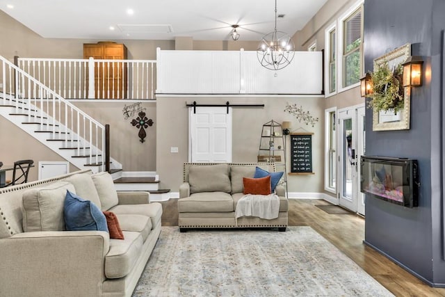 659 Creek Nation Rd, Jefferson, GA 30549 - living area with wood finished floors, a barn door, stairway, recessed lighting, and a towering ceiling