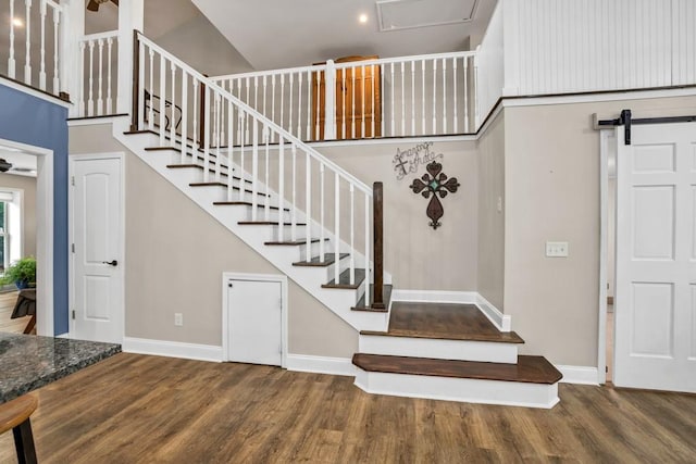 659 Creek Nation Rd, Jefferson, GA 30549 - staircase featuring wood finished floors, a towering ceiling, and a barn door