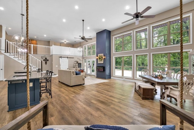 659 Creek Nation Rd, Jefferson, GA 30549 - living area with a ceiling fan, a towering ceiling, stairway, recessed lighting, and wood finished floors