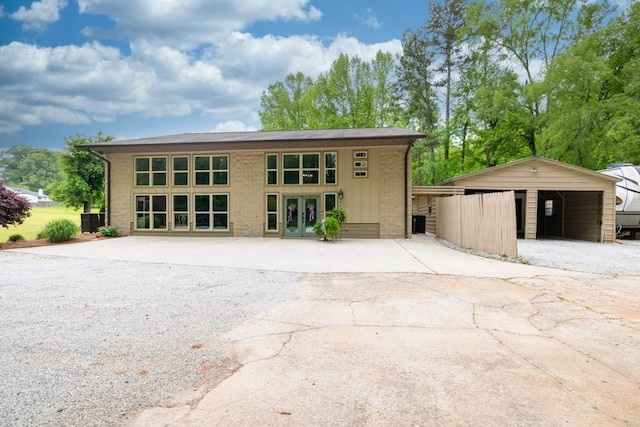 659 Creek Nation Rd, Jefferson, GA 30549 - view of front of house featuring french doors, concrete driveway, and brick siding