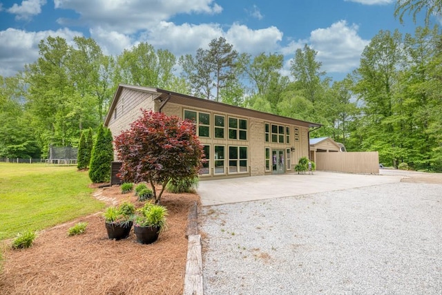 659 Creek Nation Rd, Jefferson, GA 30549 - view of front of property with a trampoline, driveway, french doors, and a patio area