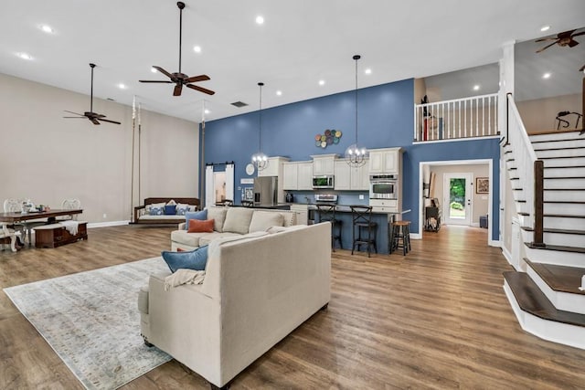659 Creek Nation Rd, Jefferson, GA 30549 - living area featuring a towering ceiling, a ceiling fan, wood finished floors, stairway, and recessed lighting