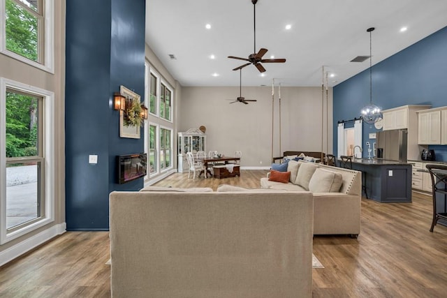 659 Creek Nation Rd, Jefferson, GA 30549 - living room with a ceiling fan, wood finished floors, recessed lighting, a towering ceiling, and a chandelier