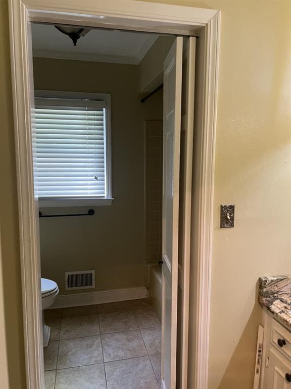 bathroom featuring vanity, ornamental molding, toilet, and tile patterned flooring