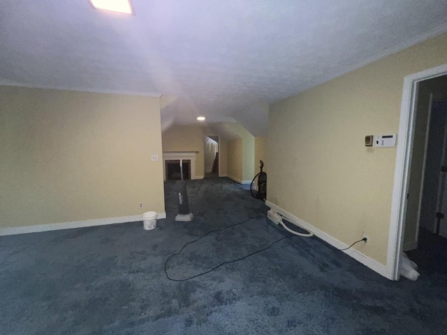 interior space with lofted ceiling and dark colored carpet