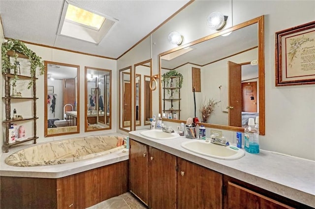 bathroom featuring vanity, a bath, ornamental molding, and vaulted ceiling with skylight