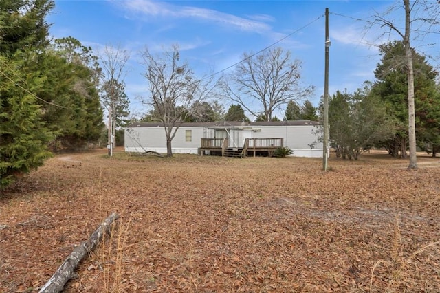 back of house with a wooden deck