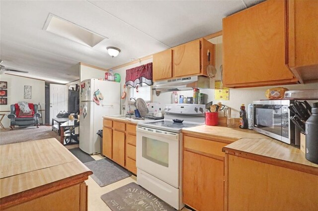 kitchen featuring under cabinet range hood, white appliances, a sink, and wooden counters