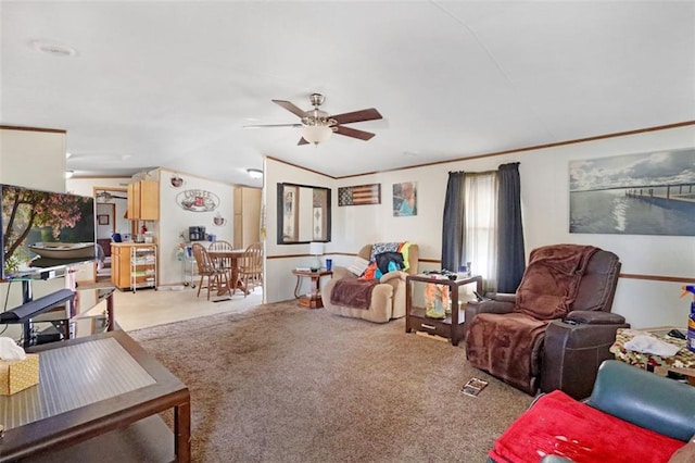 carpeted living room featuring crown molding, lofted ceiling, and ceiling fan