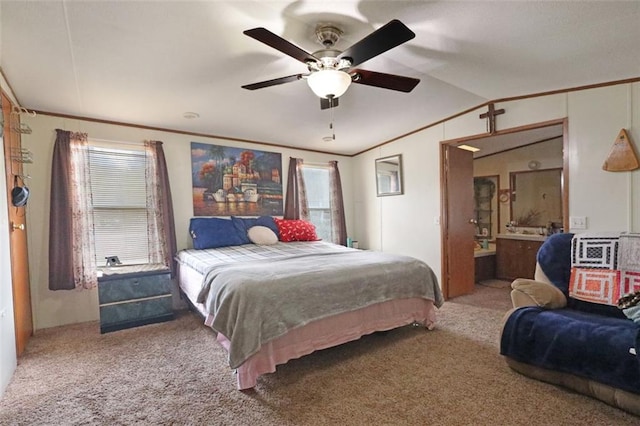 bedroom featuring vaulted ceiling, carpet floors, ornamental molding, and a ceiling fan
