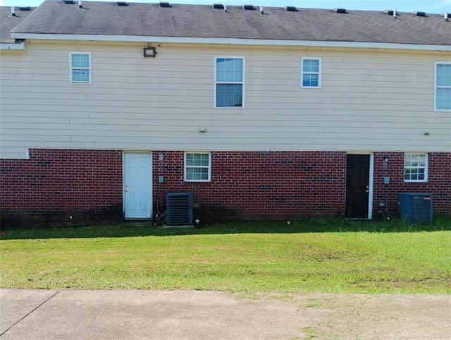 1017 Wheel House Ln Unit C, Monroe, GA 30655 - rear view of house with cooling unit, a lawn, and brick siding