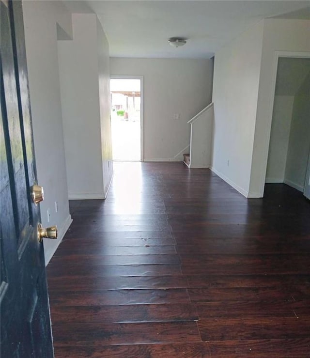 1017 Wheel House Ln Unit C, Monroe, GA 30655 - empty room with dark wood-style flooring, stairs, and baseboards