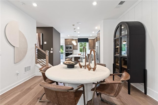 2535 Astaire Ct, Atlanta, GA 30318 - dining space with light wood-style floors, stairs, recessed lighting, and baseboards
