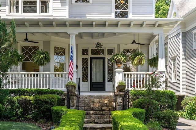 view of exterior entry featuring ceiling fan and covered porch