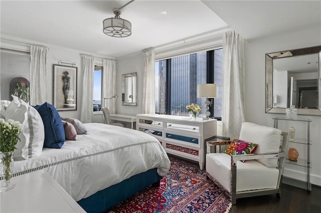 bedroom with dark hardwood / wood-style flooring