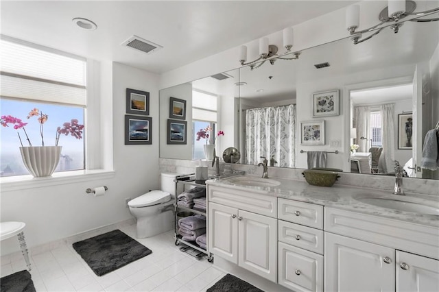 bathroom featuring tile patterned floors, vanity, and toilet