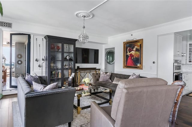 living room with ornamental molding and light wood-type flooring