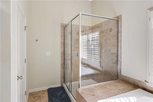 6463 Century Park Pl SE, Mableton, GA 30126 - bathroom featuring a stall shower, baseboards, and a bath