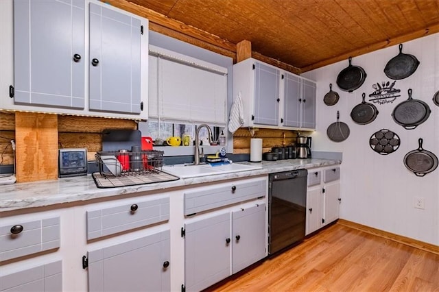 kitchen with white cabinetry, black dishwasher, sink, and light hardwood / wood-style floors