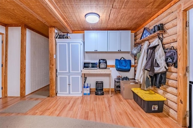 mudroom with wood ceiling, rustic walls, and light wood-type flooring