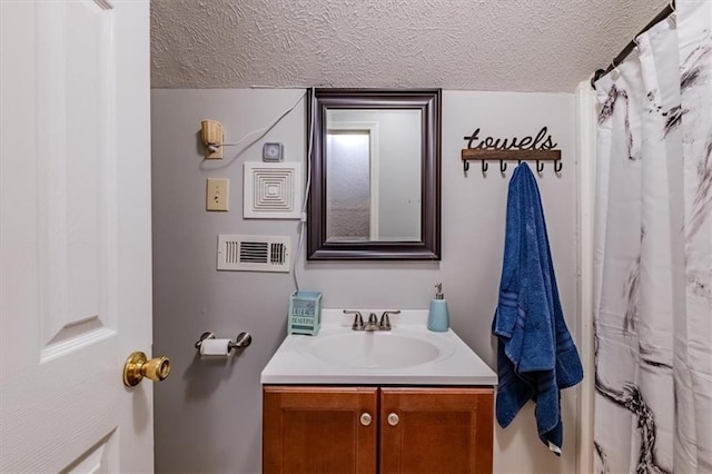 bathroom with vanity and a textured ceiling