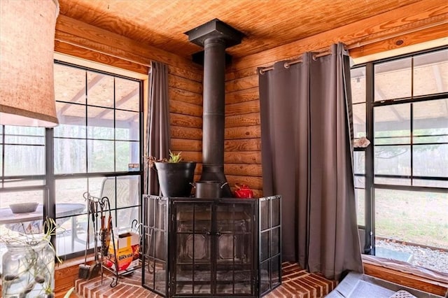 room details featuring wood ceiling, rustic walls, and a wood stove