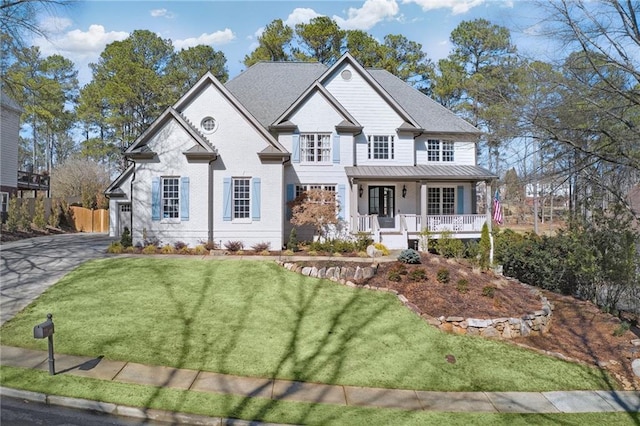 view of front of home with a front yard and covered porch