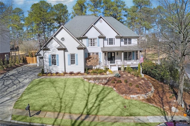 view of front of property with a porch and a front yard