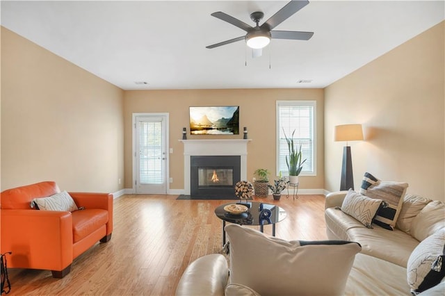 living room featuring ceiling fan and light wood-type flooring