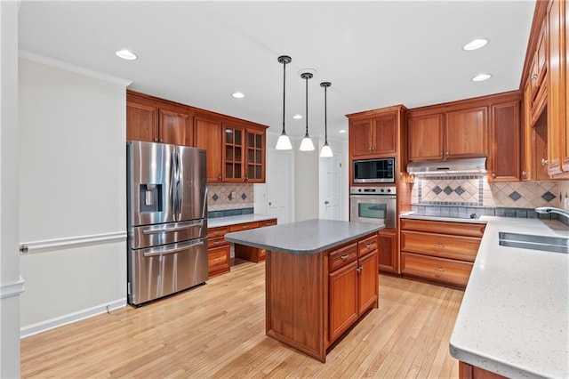 870 Richmond Hill Dr, Marietta, GA 30068 - kitchen featuring appliances with stainless steel finishes, a sink, under cabinet range hood, a kitchen island, and light wood-style floors
