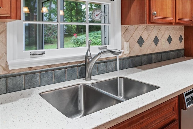870 Richmond Hill Dr, Marietta, GA 30068 - kitchen with a sink, brown cabinetry, decorative backsplash, and light stone counters