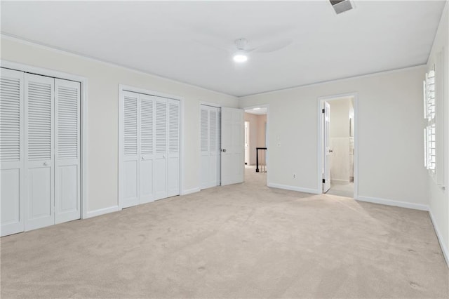 870 Richmond Hill Dr, Marietta, GA 30068 - unfurnished bedroom featuring two closets, light colored carpet, baseboards, ensuite bathroom, and ornamental molding